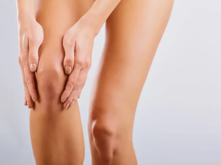 Close-up view of a knee highlighting the effects or process of knee liposuction, showcasing contour and treatment focus.